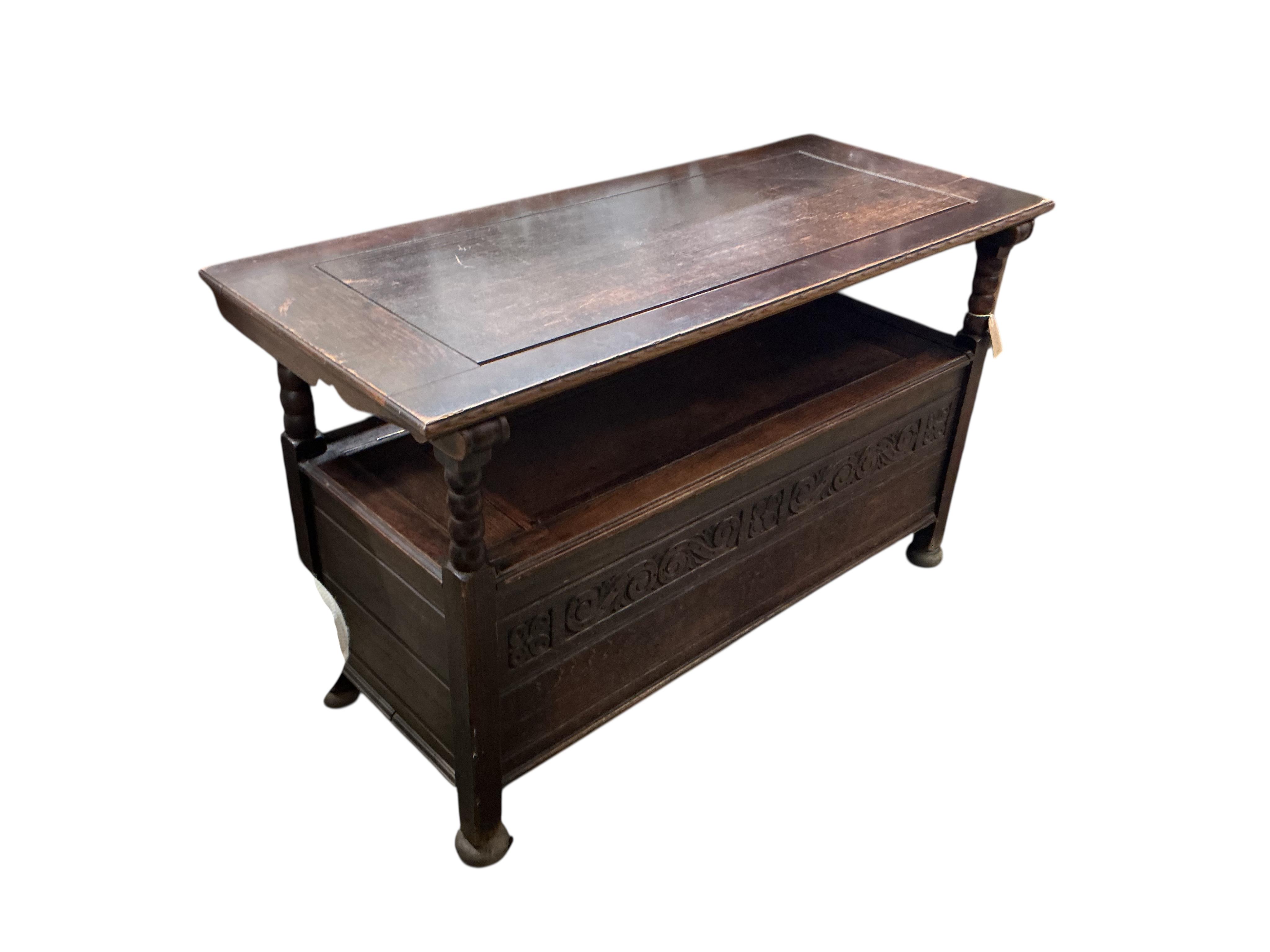 An early 20th century carved oak monks bench, width 116cm, depth 49cm, height 70cm